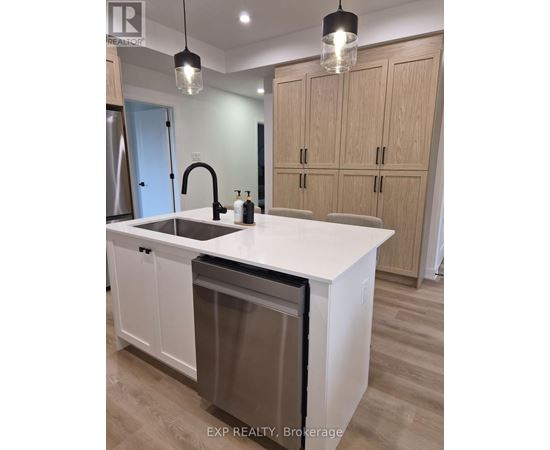 A kitchen with a white countertop and wooden cabinets.