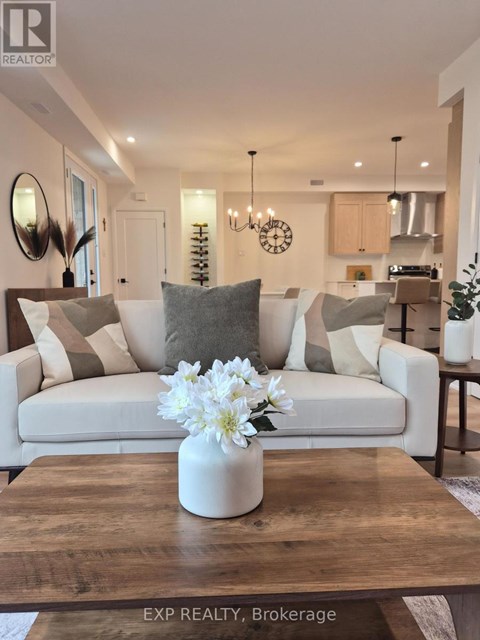 A modern living room with a white sofa and a coffee table with a vase of flowers on it.