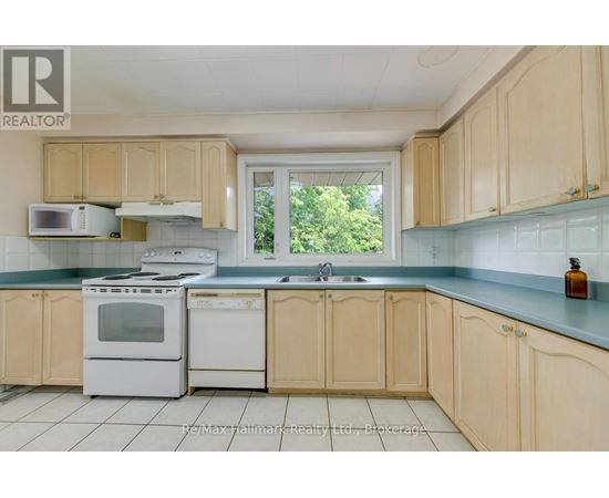 A kitchen with wooden cabinets and white appliances.