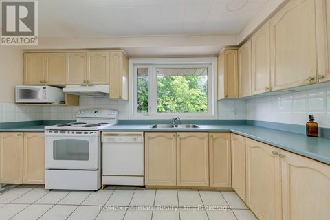 A kitchen with wooden cabinets and white appliances.