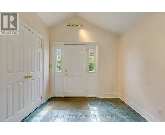 A hallway with a white door and a white wall.