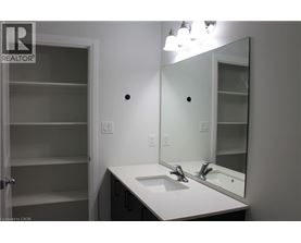 A bathroom with a sink, mirror and medicine cabinet.
