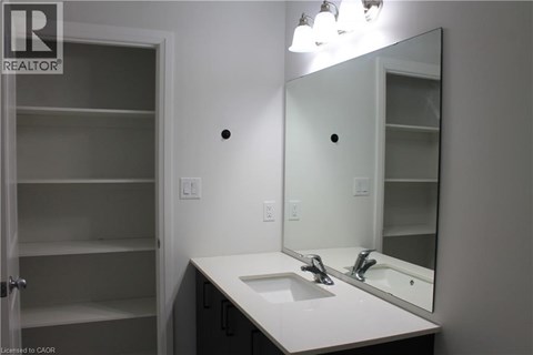A bathroom with a sink, mirror and medicine cabinet.