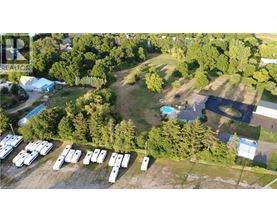 A bird's eye view of a camping site with a swimming pool and a parking lot.