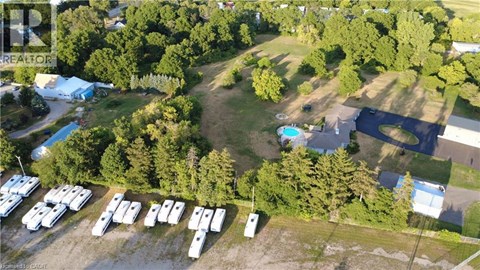 A bird's eye view of a camping site with a swimming pool and a parking lot.