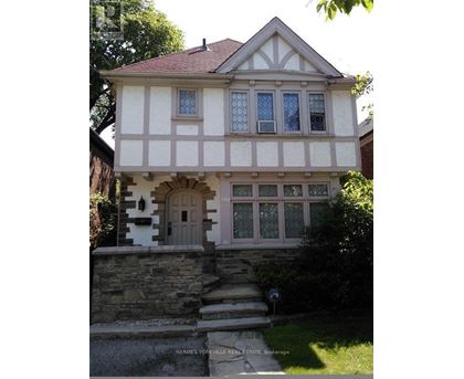 A house with a stone staircase leading to a white door.