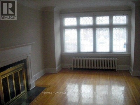 A room with a fireplace and a large window.