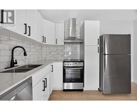 A kitchen with a stove, oven, and refrigerator.