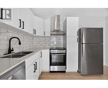 A kitchen with a stove, oven, and refrigerator.