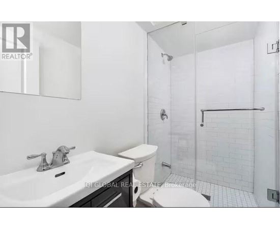 A white sink with a silver faucet in a bathroom.