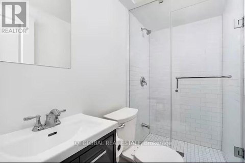 A white sink with a silver faucet in a bathroom.