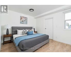 A bedroom with a bed, nightstand, and lamp.