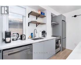 A modern kitchen with a stainless steel refrigerator, a toaster, and a coffee maker.