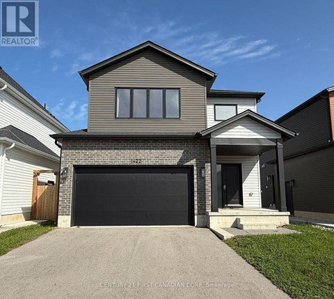 A house with a garage door is for sale.