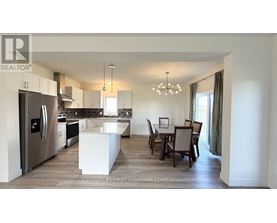 A modern kitchen with a dining table set for four.
