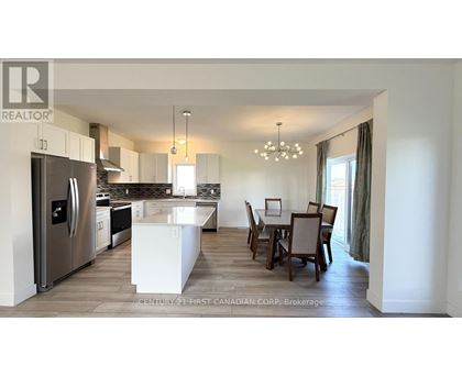 A modern kitchen with a dining table set for four.