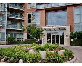 A building with the number 60 on it is surrounded by a flower bed.