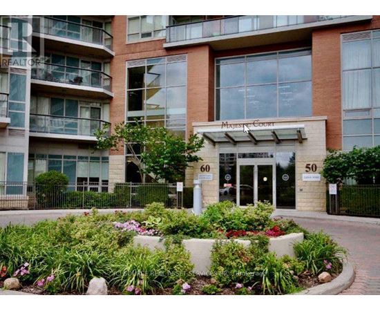 A building with the number 60 on it is surrounded by a flower bed.