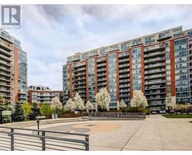 A large apartment complex with a playground in front.