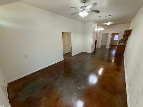 Empty room with brown floor and white walls.