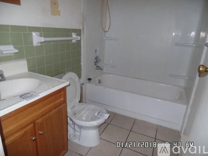A bathroom with a toilet, sink, and bathtub.