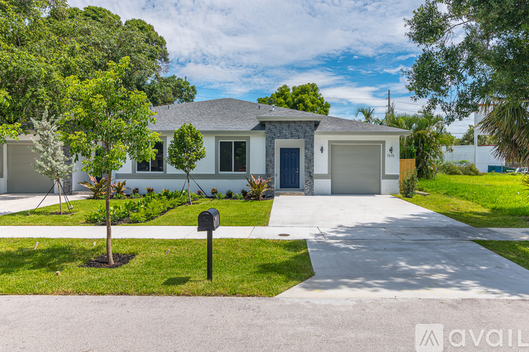 A house with a driveway and a mailbox in front.