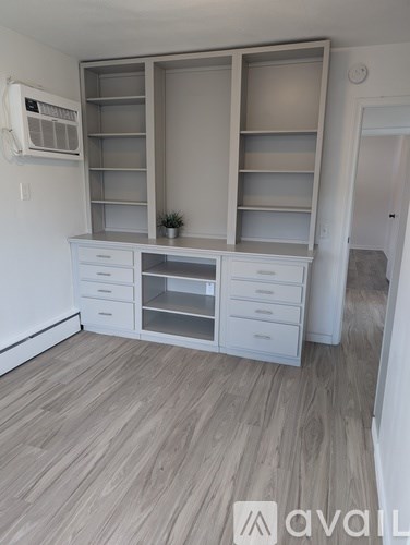 A white kitchen with a white cabinet and drawers.