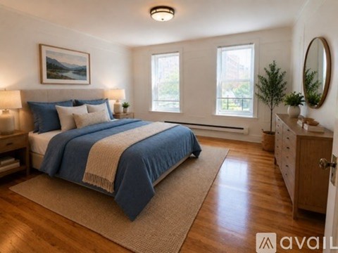 A bedroom with a large bed and a painting on the wall.
