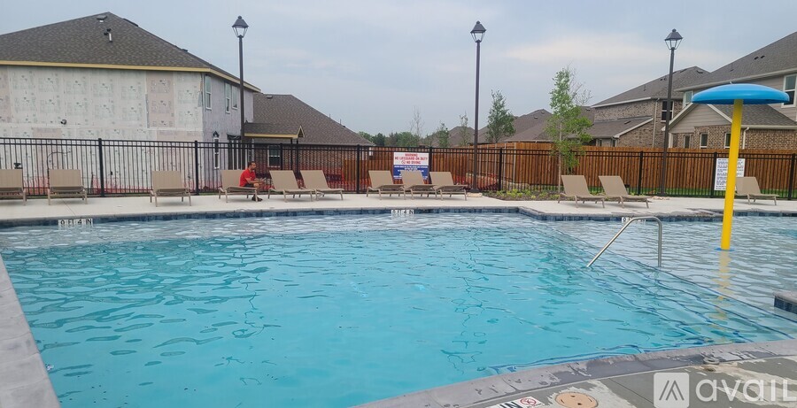 A pool with a blue water slide and a yellow pole.