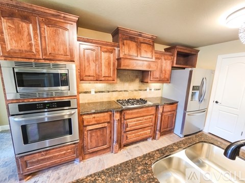 A kitchen with wooden cabinets and stainless steel appliances.