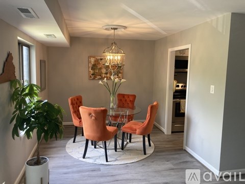 A dining room with a round table and chairs.