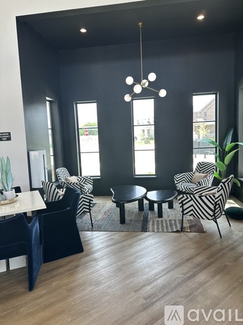 A living room with a black and white striped chair and a round table.
