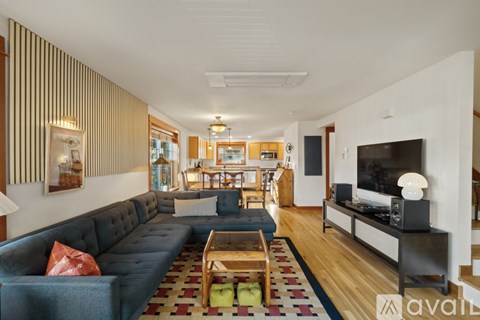 A living room with a blue couch and a television.