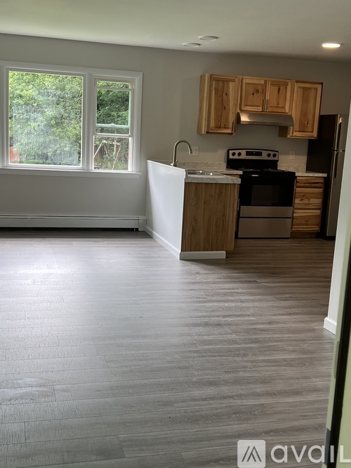 A kitchen with wooden cabinets and a white refrigerator.