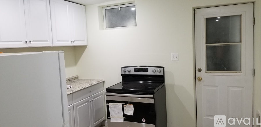 A kitchen with a stove and a refrigerator.