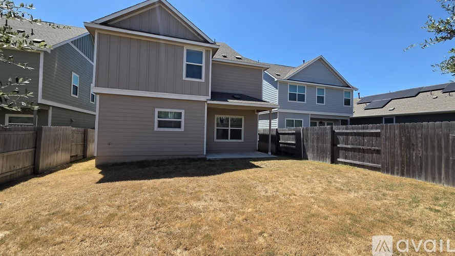 A house with a grey and brown exterior is available for rent.