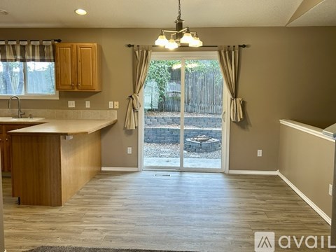 A kitchen with wooden cabinets and a countertop is shown.