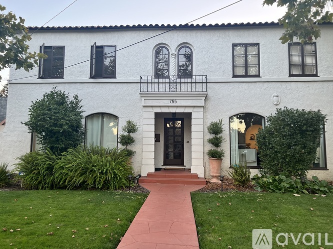 A white house with a black door and windows.