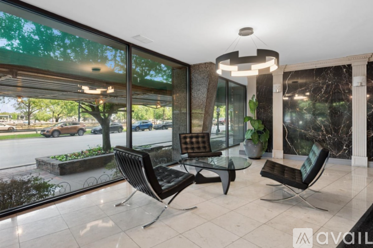 A modern living room with a glass table and chairs.