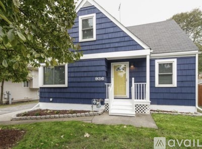 A blue house with the number 936 on the front door.