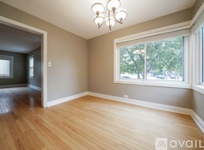 A room with wooden floors and a chandelier.