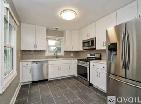 A kitchen with white cabinets and stainless steel appliances.