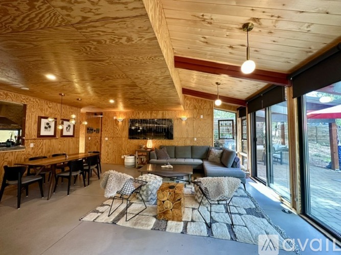 A living room with a couch, chairs, and a coffee table.