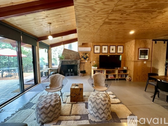 A living room with a fireplace and a chair.