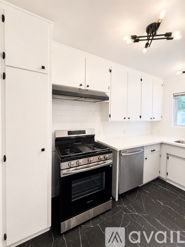 A kitchen with a stove and cabinets.