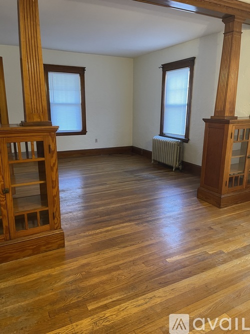 A room with wooden floors and furniture.