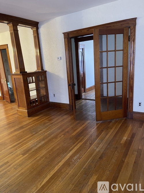 A room with wooden floors and a wooden door.