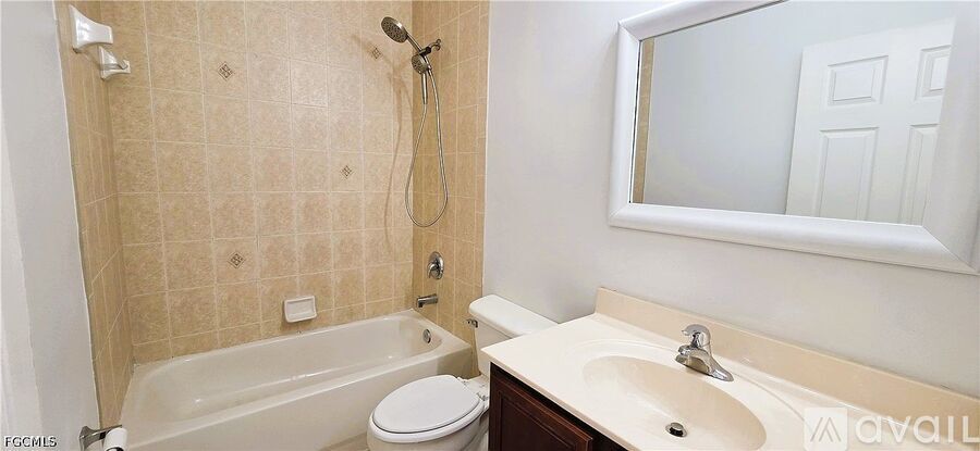 A bathroom with a toilet, sink, and bathtub.