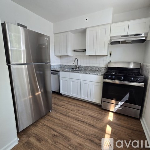 A kitchen with a stainless steel refrigerator and stove.