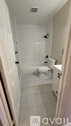 A small bathroom with a toilet and a shower.
